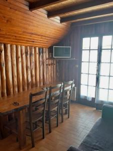 a dining room with a wooden table and chairs at Ruscadet in Campan