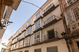 a building with windows and balconies on a street at Mi Casa es Tu Casa - Malaga Center - Fiber WiFi in Málaga