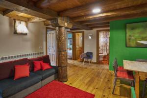 a living room with a couch and a green wall at Casa Pirineos ambos apartamentos in Ulle +37 photos