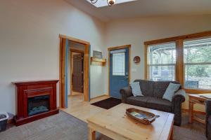 a living room with a couch and a fireplace at Huckleberry Cottage in Bend