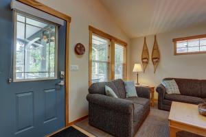 a living room with a blue door and a chair at Huckleberry Cottage in Bend