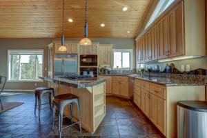 a large kitchen with wooden cabinets and counter tops at Golden Butte in Bend +21 photos