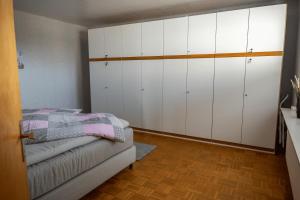 a kitchen with white cabinets and a couch in a room at Ferienwohnung Hygge und Mee-h-r in Brunsbüttel +36 photos