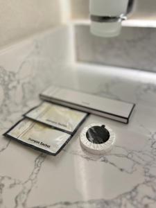 a bathroom counter with a cupcake on top of a counter at new Luxury Apartment near Masjid Quba in Al Madinah +51 photos