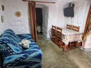 a living room with a couch and a table at Cueva de David in Guadix