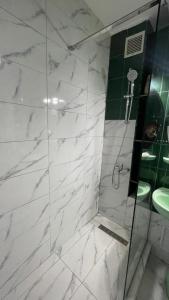 a bathroom with a shower and a sink at Apartament Panoramic Toplița in Topliţa +12 photos