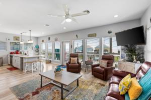 a living room with a couch and a table at 4BR w Hot Tub Gameroom OceanView by Bolivar Vacations in Bolivar Peninsula