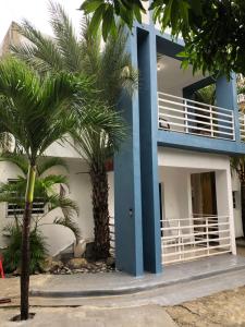 a building with palm trees in front of it at VILLAS SONJASAA LOFt in Baní