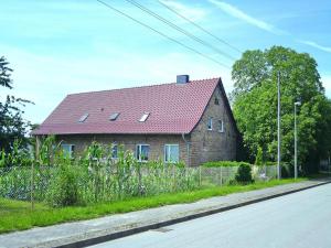 a brick house with a red roof on a street at Ferienwohnung, Parmen bei Feldberg in Parmen