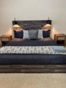 a bedroom with a large bed with two tables at By Wedding Venues, Central AC, Hot Tub & Game Room in Puyallup +45 photos
