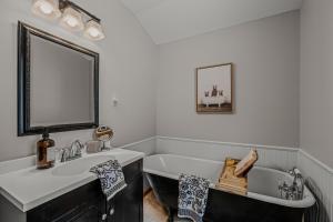 a bathroom with a sink and a bath tub at Sqyrls Nest - Hot Tub, Pet Friendly, Screen Porch, Grill, Wifi, Fire Pit, Deck, View, Family Friendly, Game Room, Shuffle Board, Wood Stove in Berkeley Springs +53 photos