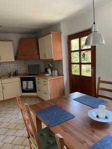 a kitchen with a wooden table and a dining room at Stilvolle 3 Zimmer-Wohnung auf saniertem Resthof in Reher