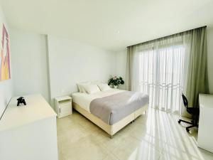 Postel nebo postele na pokoji v ubytování La Pimentera Penthouse - Casa Banderas