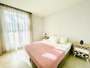 Postel nebo postele na pokoji v ubytování La Pimentera Penthouse - Casa Banderas