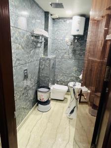 a bathroom with a shower and a toilet in it at Hotel 24 STAR INN in Jāmb
