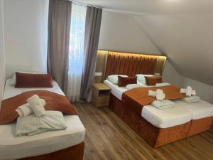 a bedroom with two beds and a window at Pension Rexha am Weißensee in Füssen