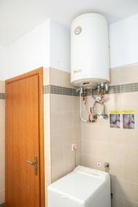 a small bathroom with a toilet and a light at Igoumenitsa View - Marinos in Igoumenitsa +34 photos