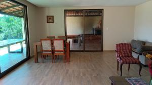 a dining room with a table and chairs at Casa de campo Serra do Cipó in Serra do Cipo