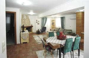 a living room with a table and a couch at villa ioanna eretria in Eretria