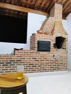 a brick oven with a table with a glass on it at Sítio Martinelli, Caravaggio in Santa Teresa