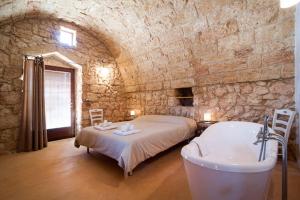 Postel nebo postele na pokoji v ubytování Agriturismo Le Fornelle
