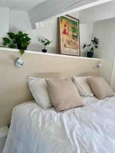 a white bed with two pillows in a bedroom at Nid du port in Grimaud