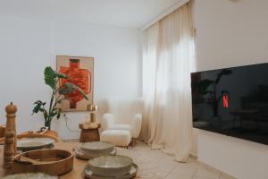 a living room with a table with bowls on it at The Boho Blue in Igoumenitsa