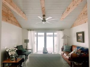 a living room with a ceiling fan and a couch at Lakefront Girls getaway Romantic Retreat low fees in Howe