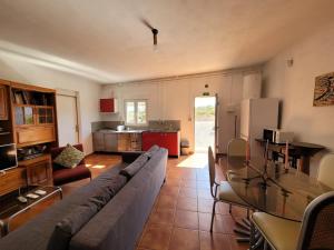 a living room with a couch and a glass table at Sítio da Cornucópia Casa Principal in Moncarapacho