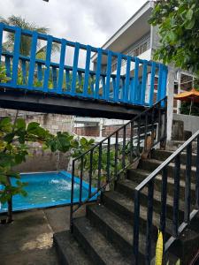 a blue bridge over a stairs next to a swimming pool at Hotel Silver Lake in Santa Ana