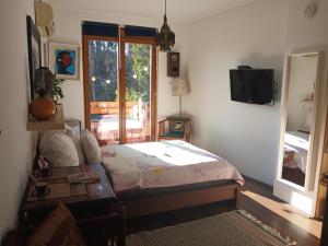 a bedroom with a bed and a tv on the wall at Cozy studio at the Castle in Budapest