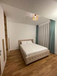 a bedroom with a bed and a green curtain at AME Summer - Onix Blue Mamaia Nord in Mamaia Nord