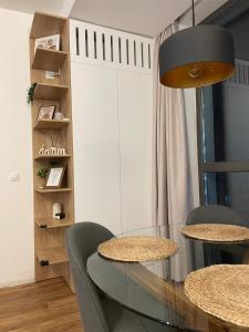 a dining room with a glass table and chairs at AME Summer - Onix Blue Mamaia Nord in Mamaia Nord