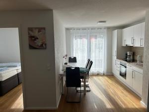 a kitchen and dining room with a table and chairs at Ferienwohnung Sonnenblick in Hilzingen