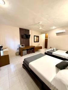 Ένα ή περισσότερα κρεβάτια σε δωμάτιο στο Hotel Baroni