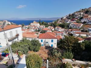 a view of a town with houses on a hill at Tsitsinakis Traditional Home in Hydra