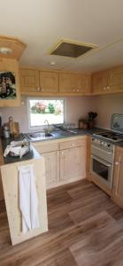 a kitchen with a sink and a stove top oven at La Petite Maison dans La Mégie Tiny House in Troche +18 photos