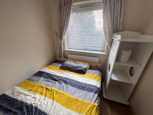 a small bedroom with a bed and a window at Double bedroom with shower in Wokingham +16 photos