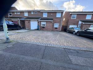 a brick parking lot in front of a brick building at Double bedroom with shower in Wokingham
