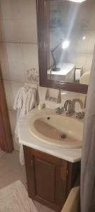 a bathroom with a sink and a mirror and towels at Tsitsinakis Traditional Home in Hydra +95 photos