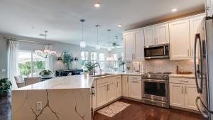 a kitchen with white cabinets and a stove top oven at Queen Creek #151 Chandler in Chandler