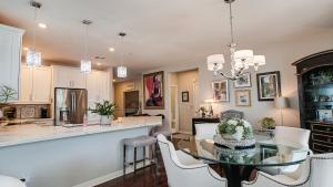 a kitchen and dining room with a glass table and chairs at Queen Creek #151 Chandler in Chandler +49 photos