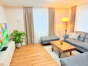 a living room with a couch and a table at Rennglück Apartments in Kelberg