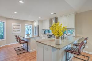 a kitchen with white cabinets and a counter with yellow flowers at 3032 Marsh Haven in Johns Island