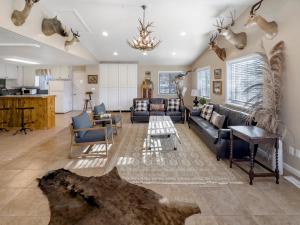 a living room with a couch and a table at Mountain Meadow Retreat near Park City in Peoa