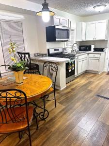 a kitchen with a table and a table and chairs at LOVELY FURNISHED HOUSE FOR rent in Akron