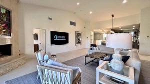 een woonkamer met een bank en een open haard bij The Suite Spot in Rancho Mirage