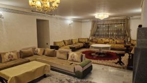 a large living room with couches and a table at Appt Fes centre ville in Fez