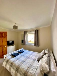 a bedroom with a bed and a window at Fort William - Highland holiday home in Fort William