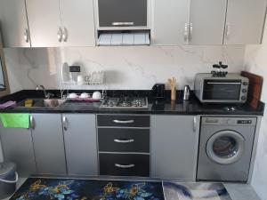 a kitchen with a stove and a microwave at Casa Salvador 1 boujdour in Cabo Bojador